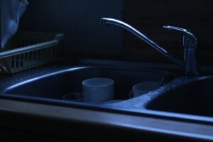 kitchen sink with standing water and garbage disposal